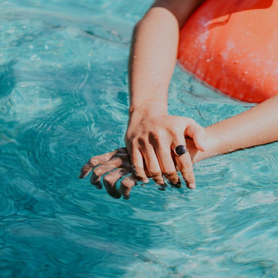 woman relaxes on a floatie in swimming pool